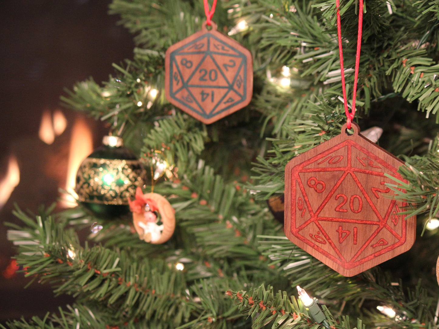 Black Walnut Christmas ornaments in two sizes, in the style of a D20 dice, with green and red resin infilled engravings.